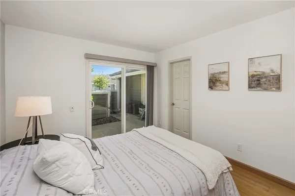 a bedroom with a bed and a lamp