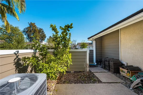 a view of a backyard with plants and a patio