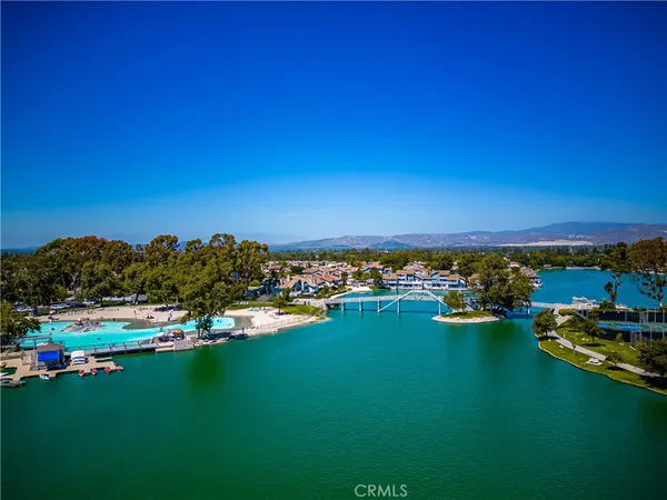 a view of a town with swimming pool and trees in the background