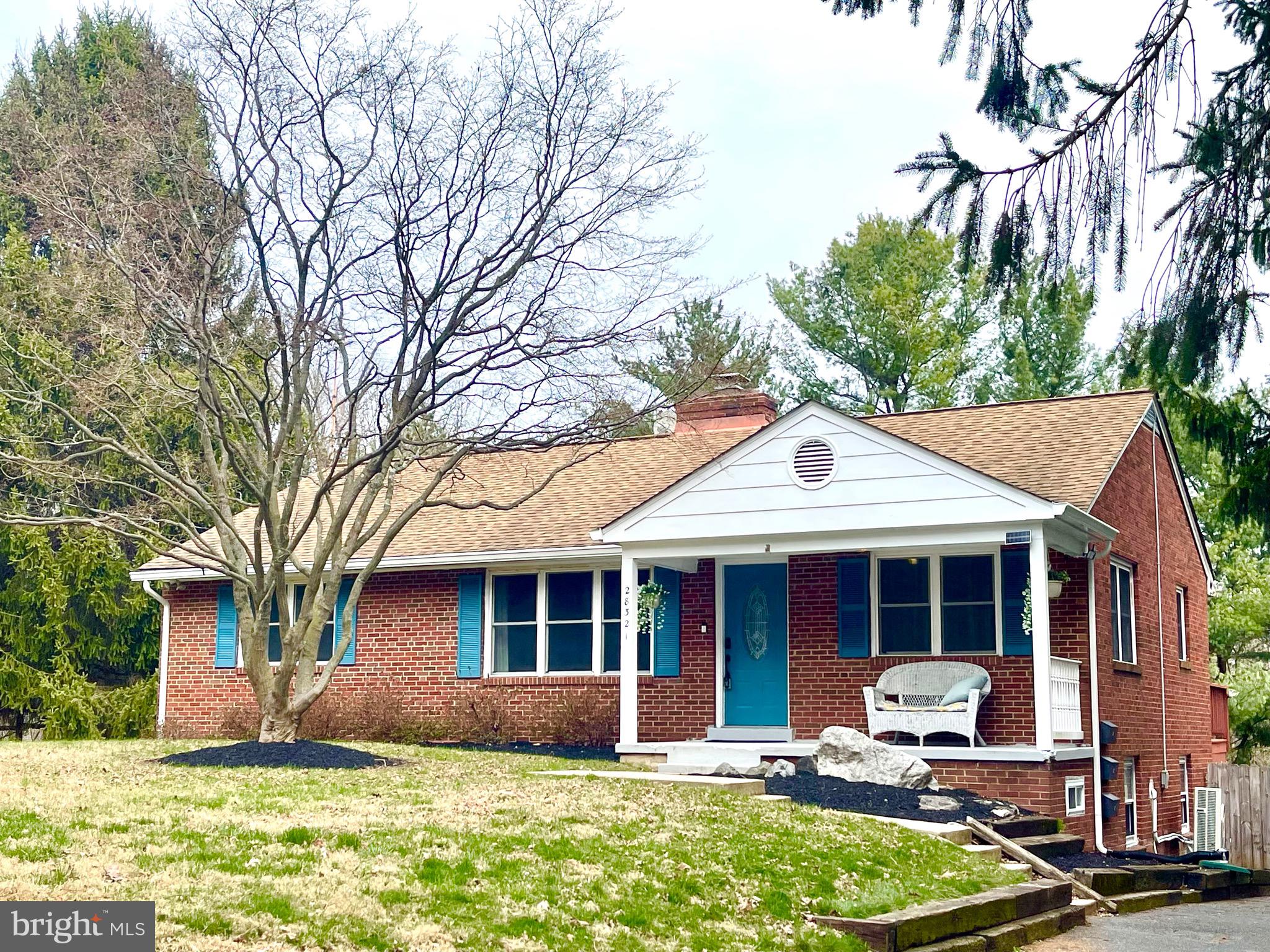 a front view of a house with garden and porch
