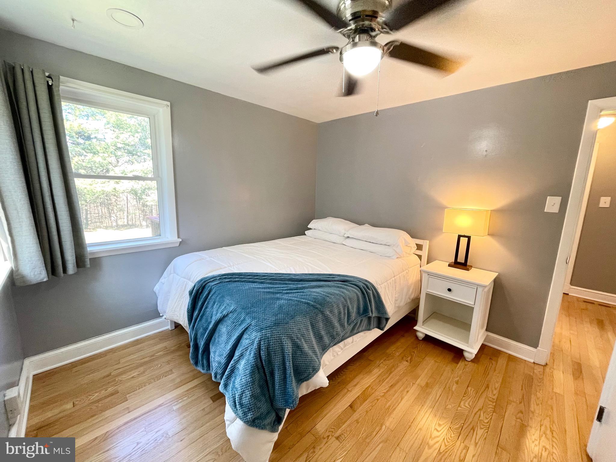 28321 Kemptown Road Damascus, MD 20872 - Photo 13 of 57 a bedroom with a bed and wooden floor