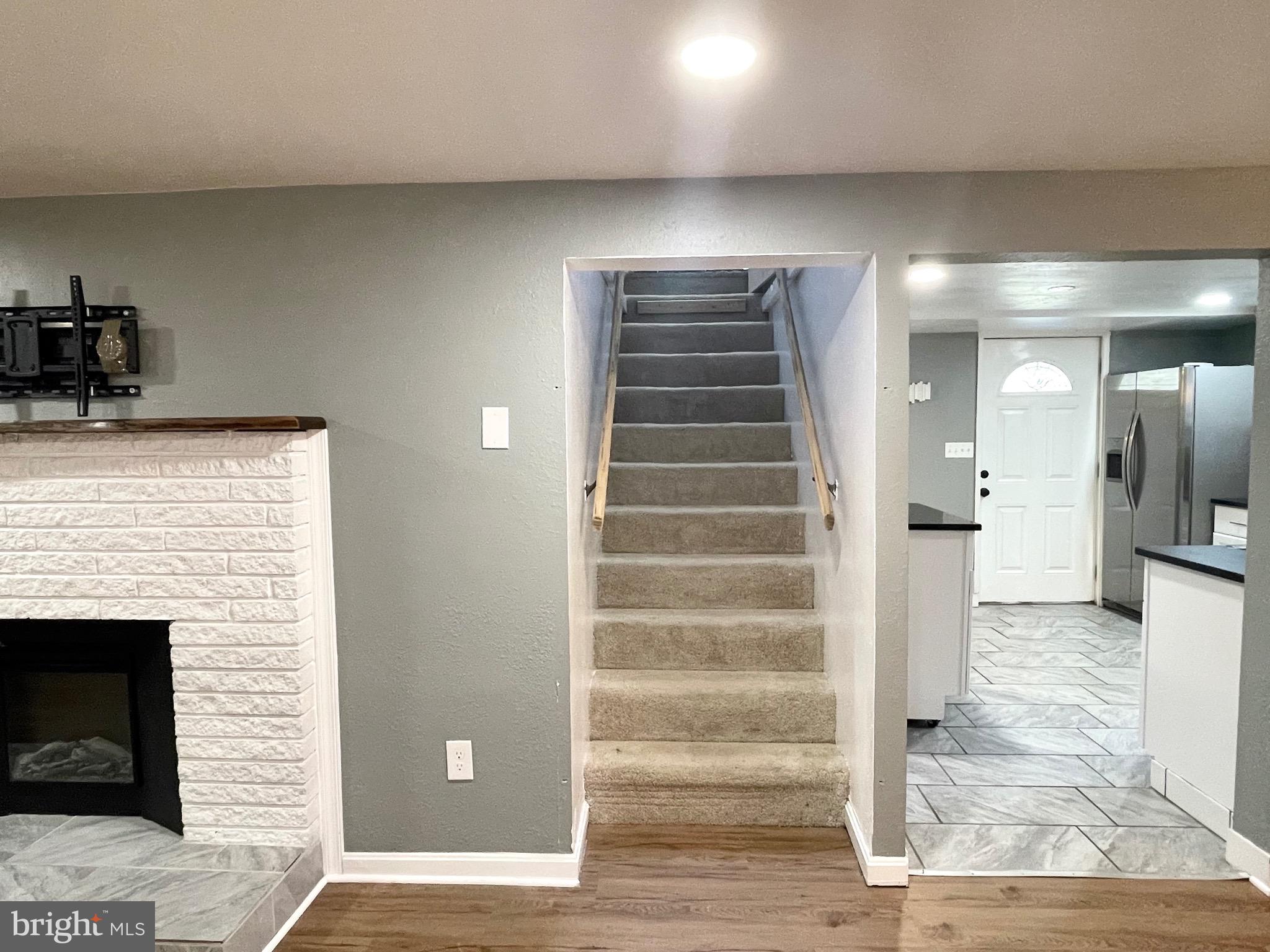 28321 Kemptown Road Damascus, MD 20872 - Photo 17 of 57 a view of a hallway with wooden floor and staircase
