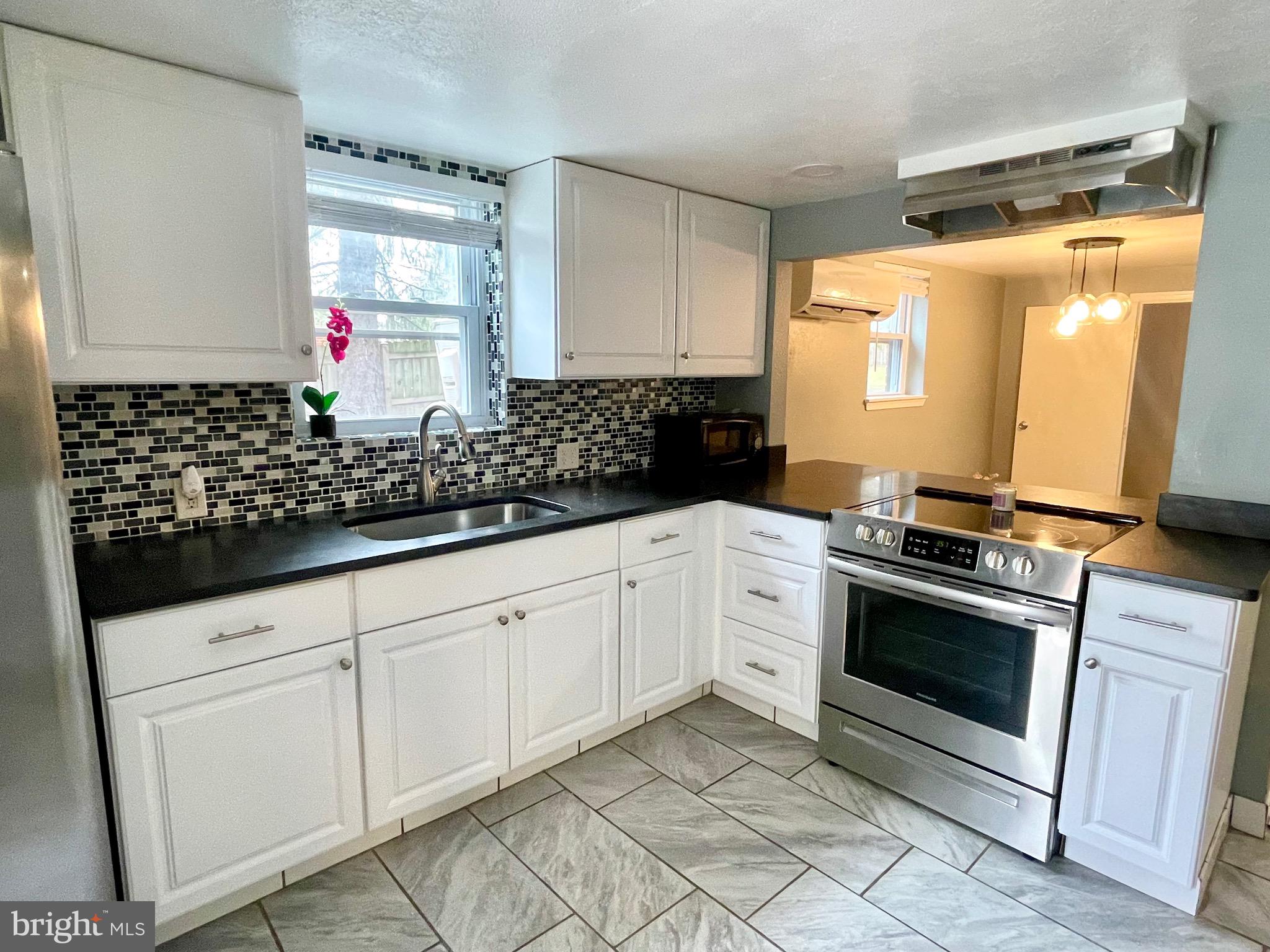 28321 Kemptown Road Damascus, MD 20872 - Photo 20 of 57 a kitchen with stainless steel appliances granite countertop a sink stove and cabinets