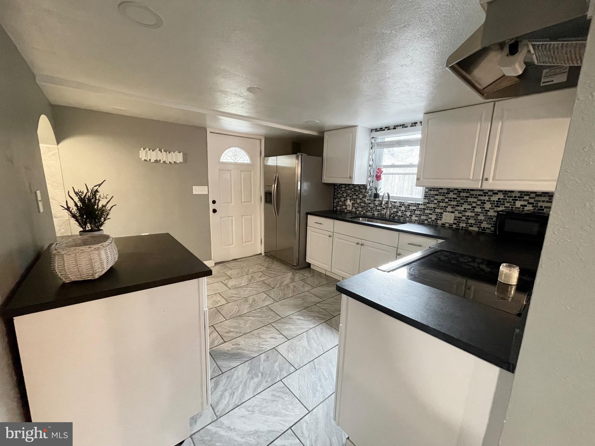 28321 Kemptown Road Damascus, MD 20872 - Photo 22 of 57 a kitchen with stainless steel appliances a stove a sink and a refrigerator