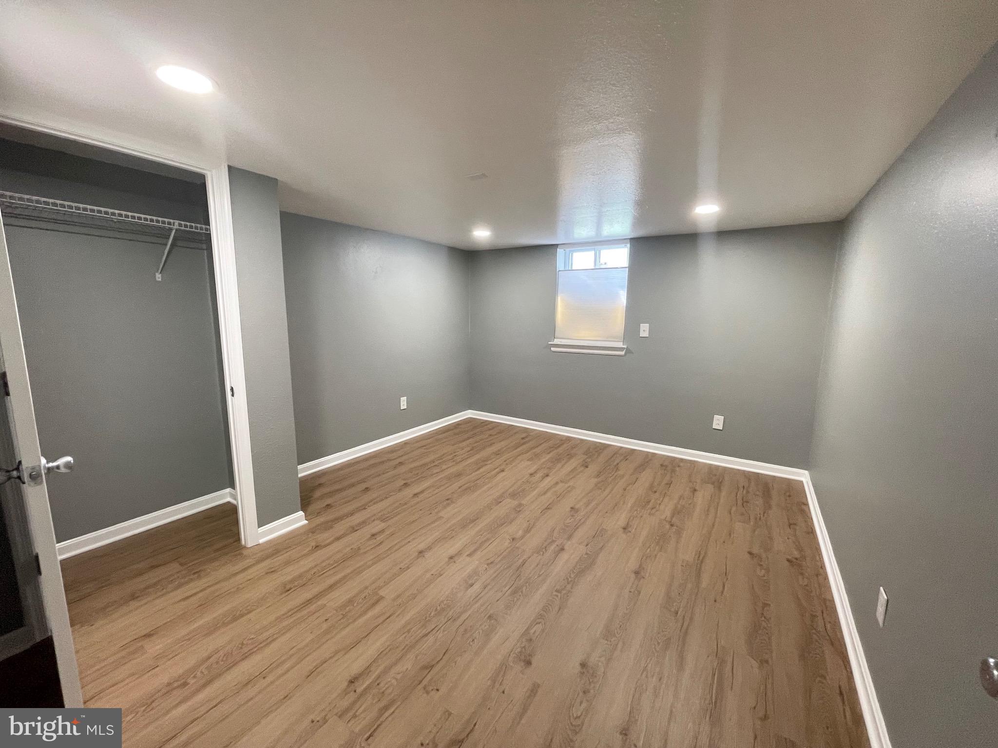 28321 Kemptown Road Damascus, MD 20872 - Photo 25 of 57 an empty room with wooden floor and windows