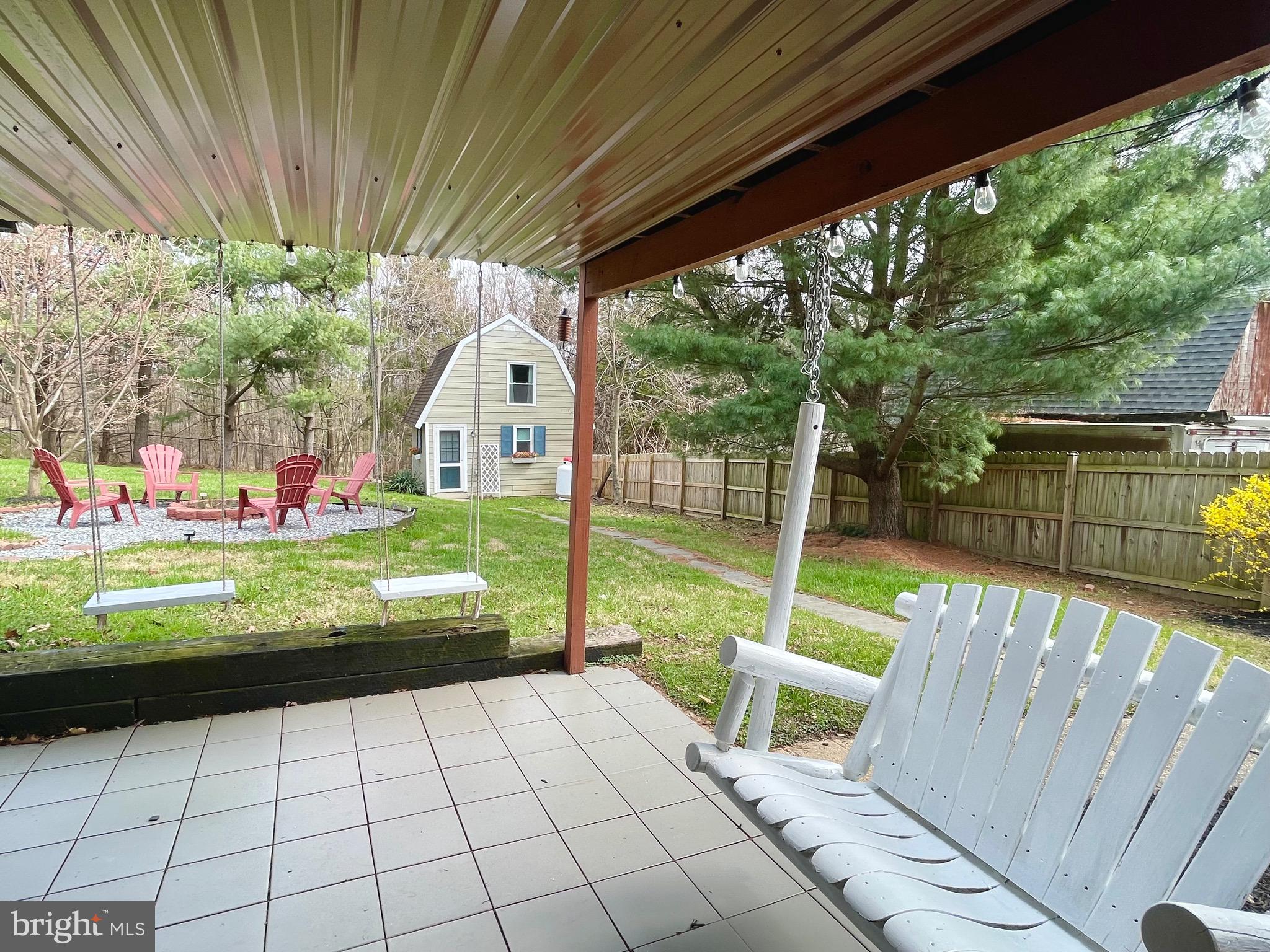 28321 Kemptown Road Damascus, MD 20872 - Photo 35 of 57 a view of a chair and tables in the backyard