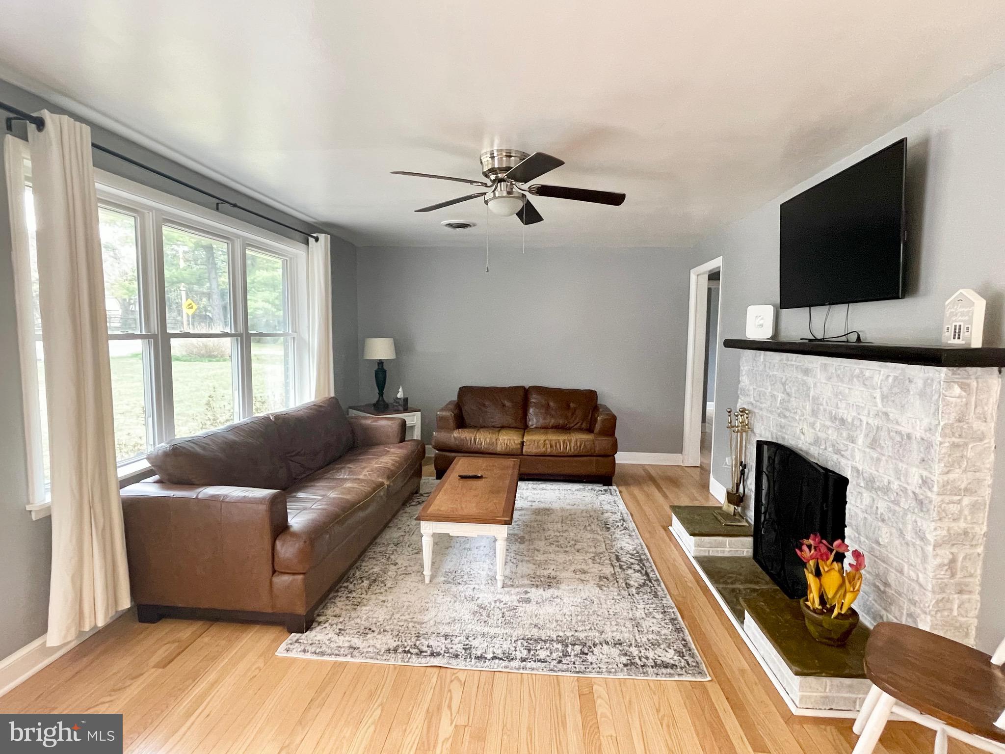 28321 Kemptown Road Damascus, MD 20872 - Photo 4 of 57 a living room with furniture fireplace and flat screen tv