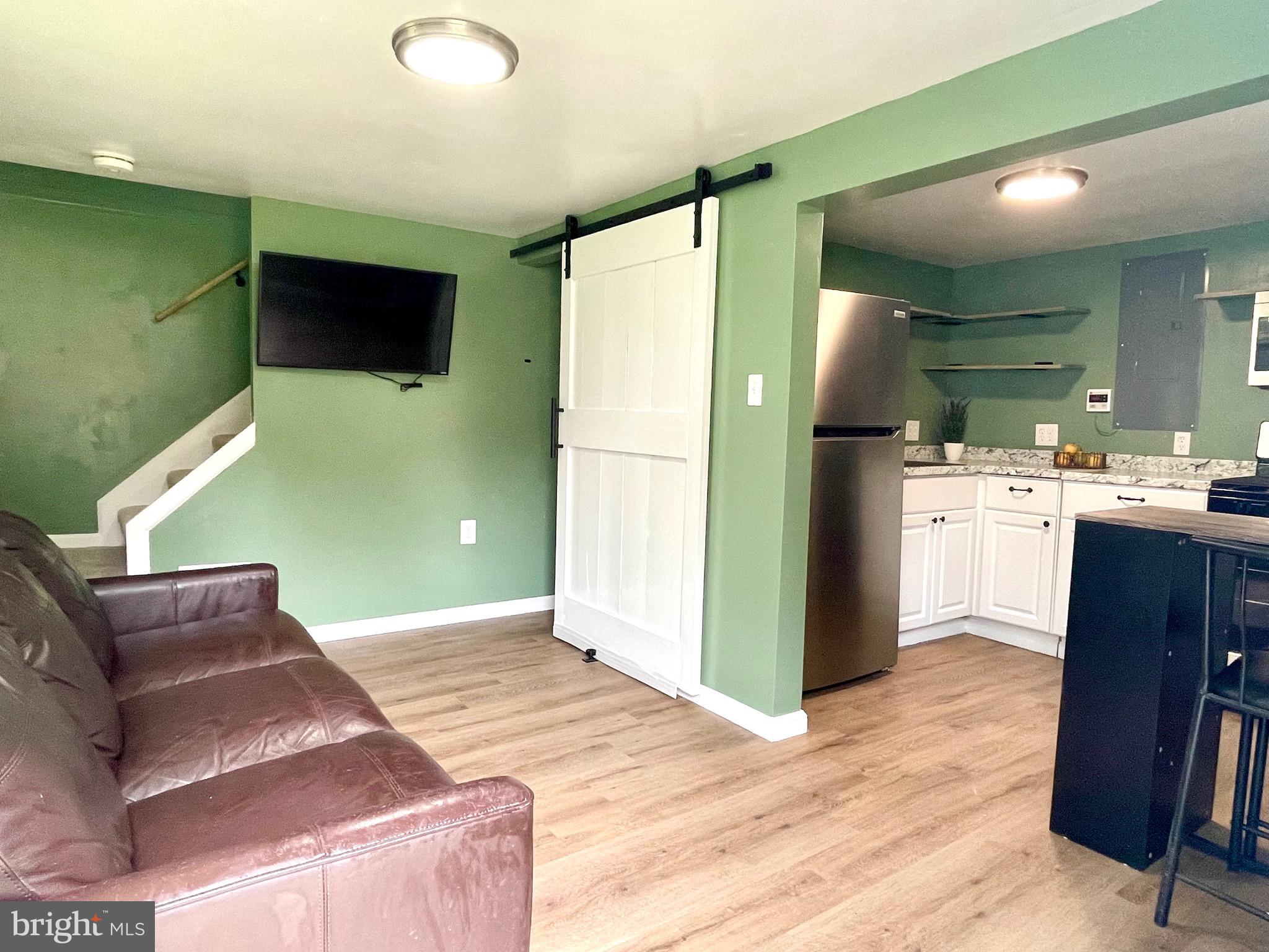 28321 Kemptown Road Damascus, MD 20872 - Photo 42 of 57 a kitchen with stainless steel appliances kitchen island granite countertop a refrigerator a stove top oven with a sink and dishwasher