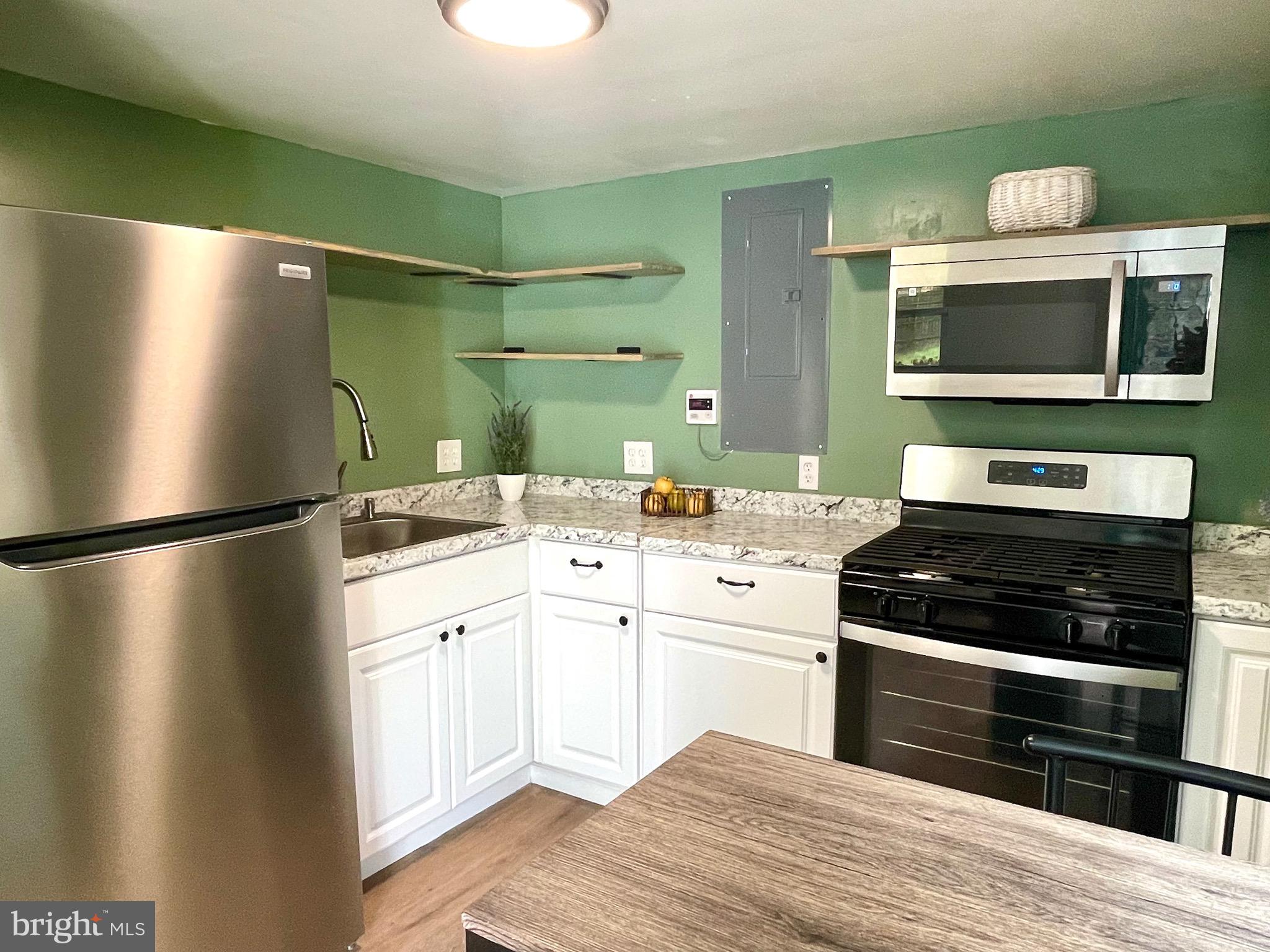 28321 Kemptown Road Damascus, MD 20872 - Photo 43 of 57 a kitchen with a refrigerator and a sink