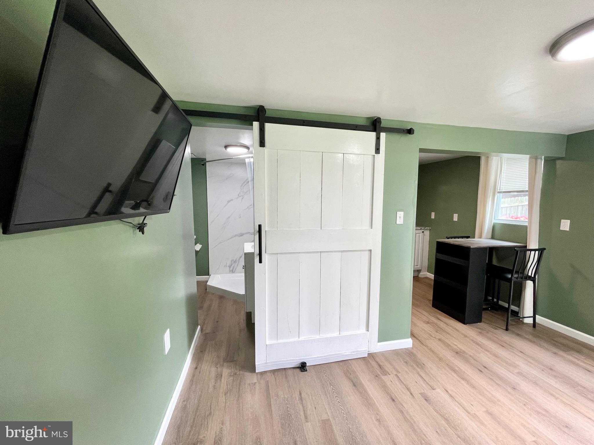 28321 Kemptown Road Damascus, MD 20872 - Photo 45 of 57 a view of a hallway with wooden floor and staircase