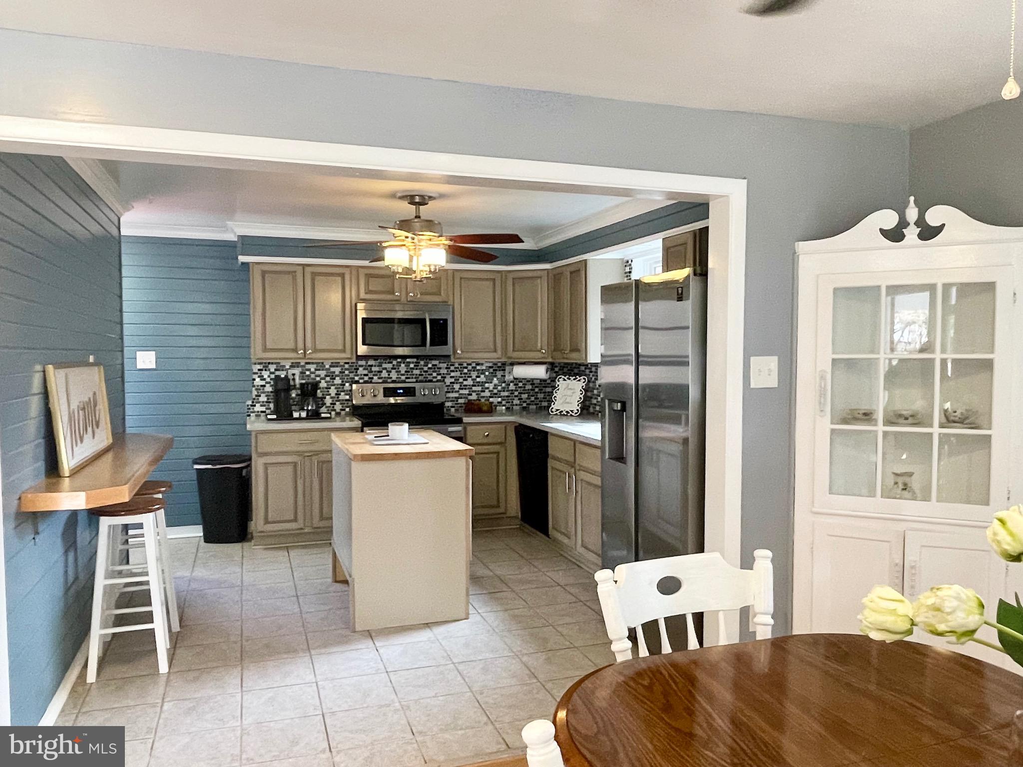 28321 Kemptown Road Damascus, MD 20872 - Photo 8 of 57 a kitchen with a refrigerator and wooden cabinets