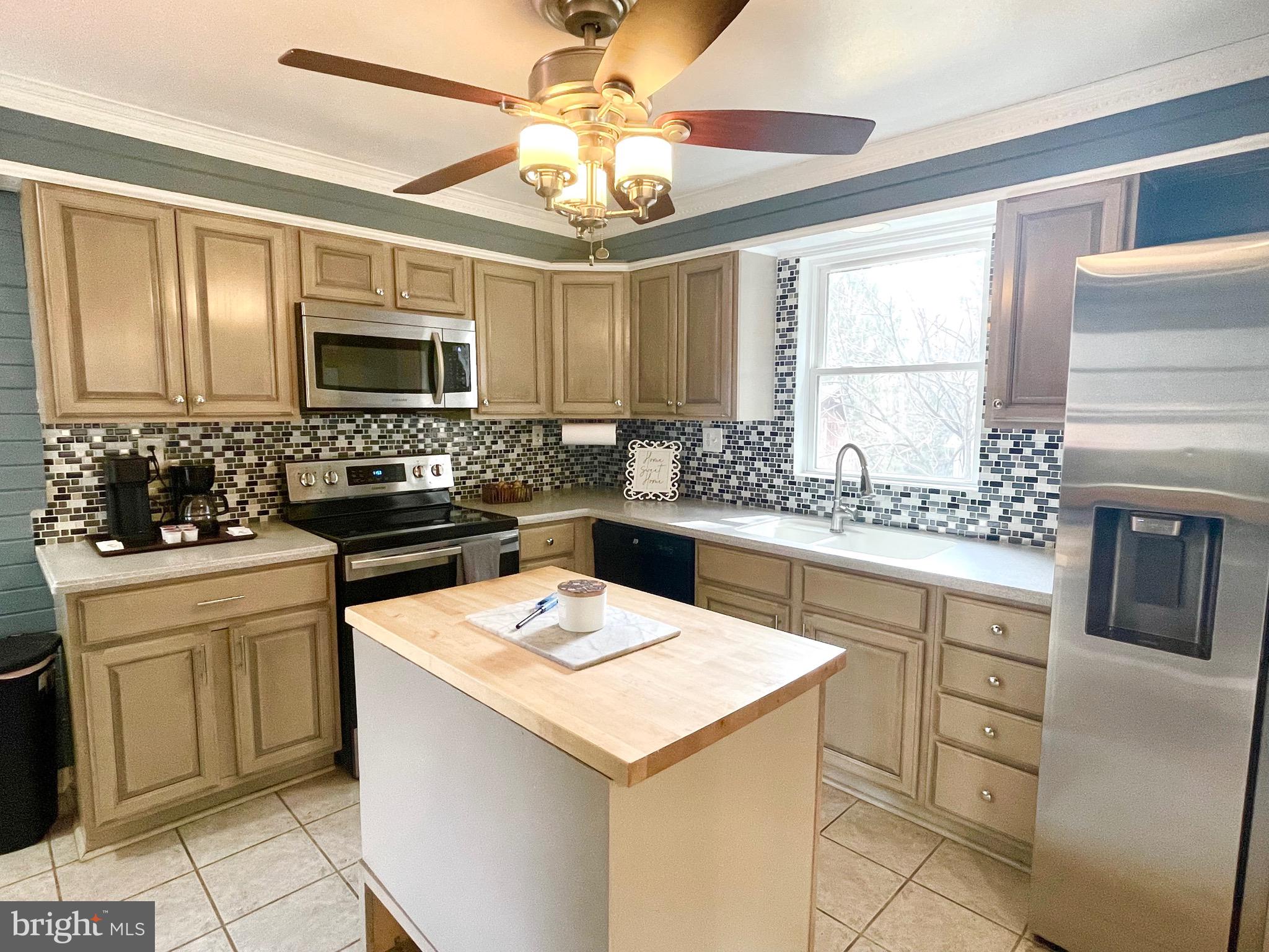 28321 Kemptown Road Damascus, MD 20872 - Photo 9 of 57 a kitchen with a stove a sink and a refrigerator