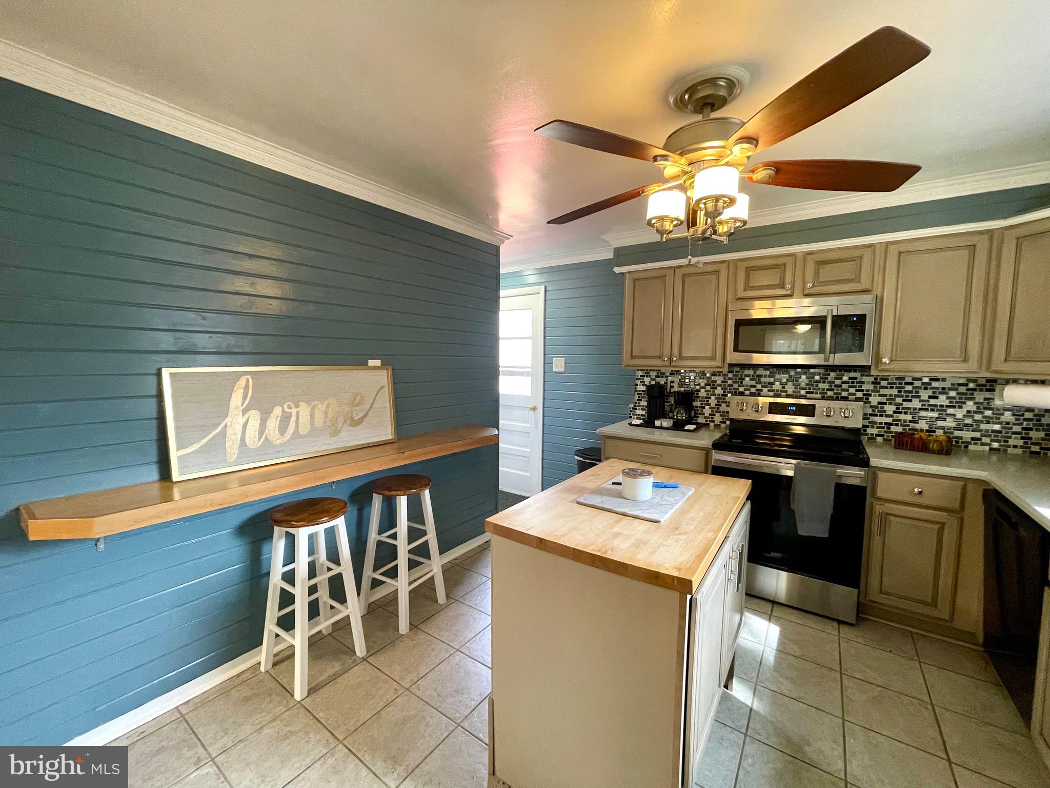 28321 Kemptown Road Damascus, MD 20872 - Photo 10 of 57 a kitchen with stainless steel appliances granite countertop a stove a sink and a microwave
