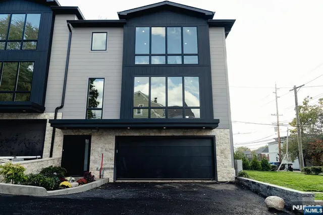 a view of a house with a yard and garage