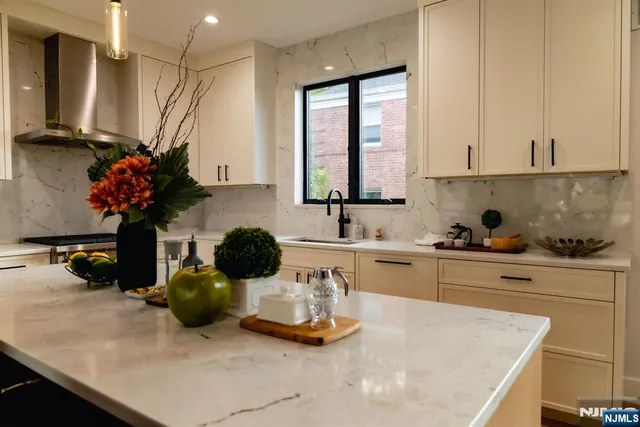 a kitchen with sink a window and cabinets