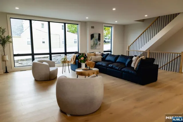 a living room with furniture window and a wooden floor
