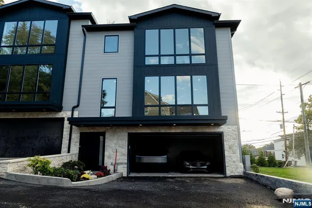 a kitchen with stainless steel appliances kitchen island granite countertop a table chairs sink and cabinets