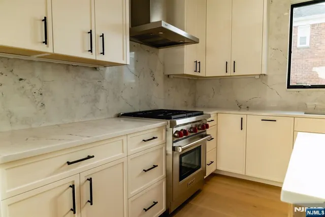 a kitchen with granite countertop a stove and a sink