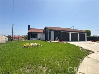 a view of house with backyard space and garden