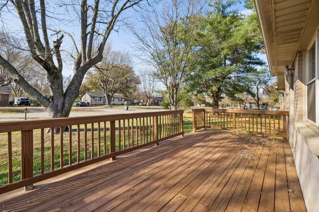 a view of backyard of house and trees