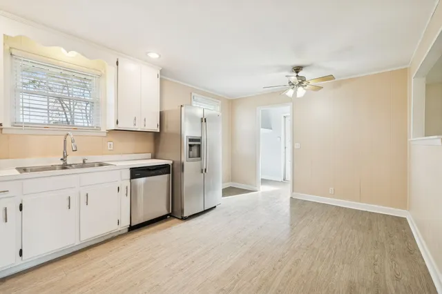 a kitchen with white cabinets and stainless steel appliances