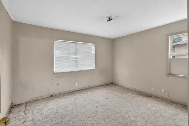 an aerial view of a house with a garden and lake view