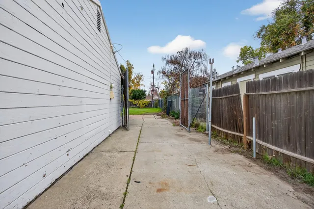 a view of a backyard with barn and wooden fence