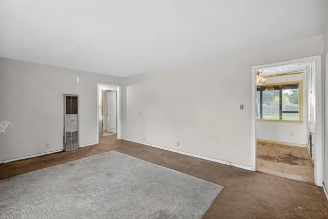 an open kitchen with a sink and refrigerator