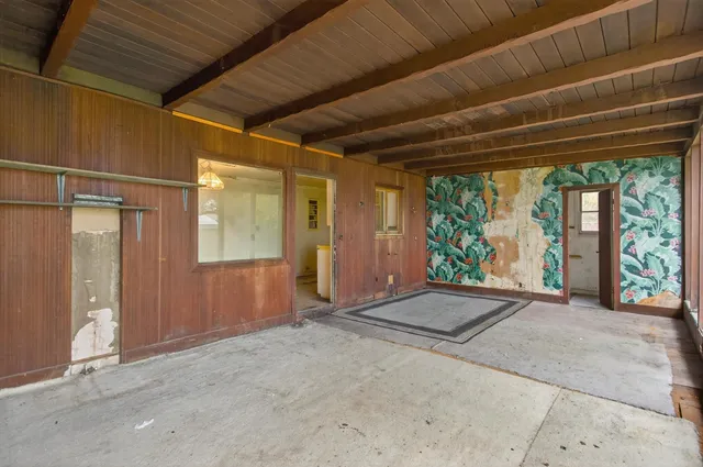 a view of an empty room with large windows