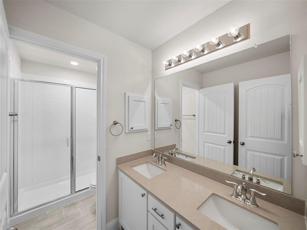 1505 Pegasus Drive Lancaster, TX 75134 - Photo 2 of 10 a bathroom with double vanity sinks and a mirror