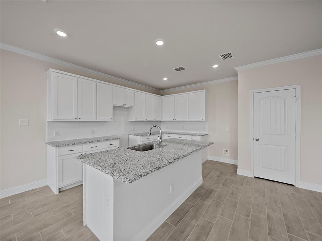 1505 Pegasus Drive Lancaster, TX 75134 - Photo 8 of 10 a kitchen with stainless steel appliances granite countertop a sink and a granite counter tops