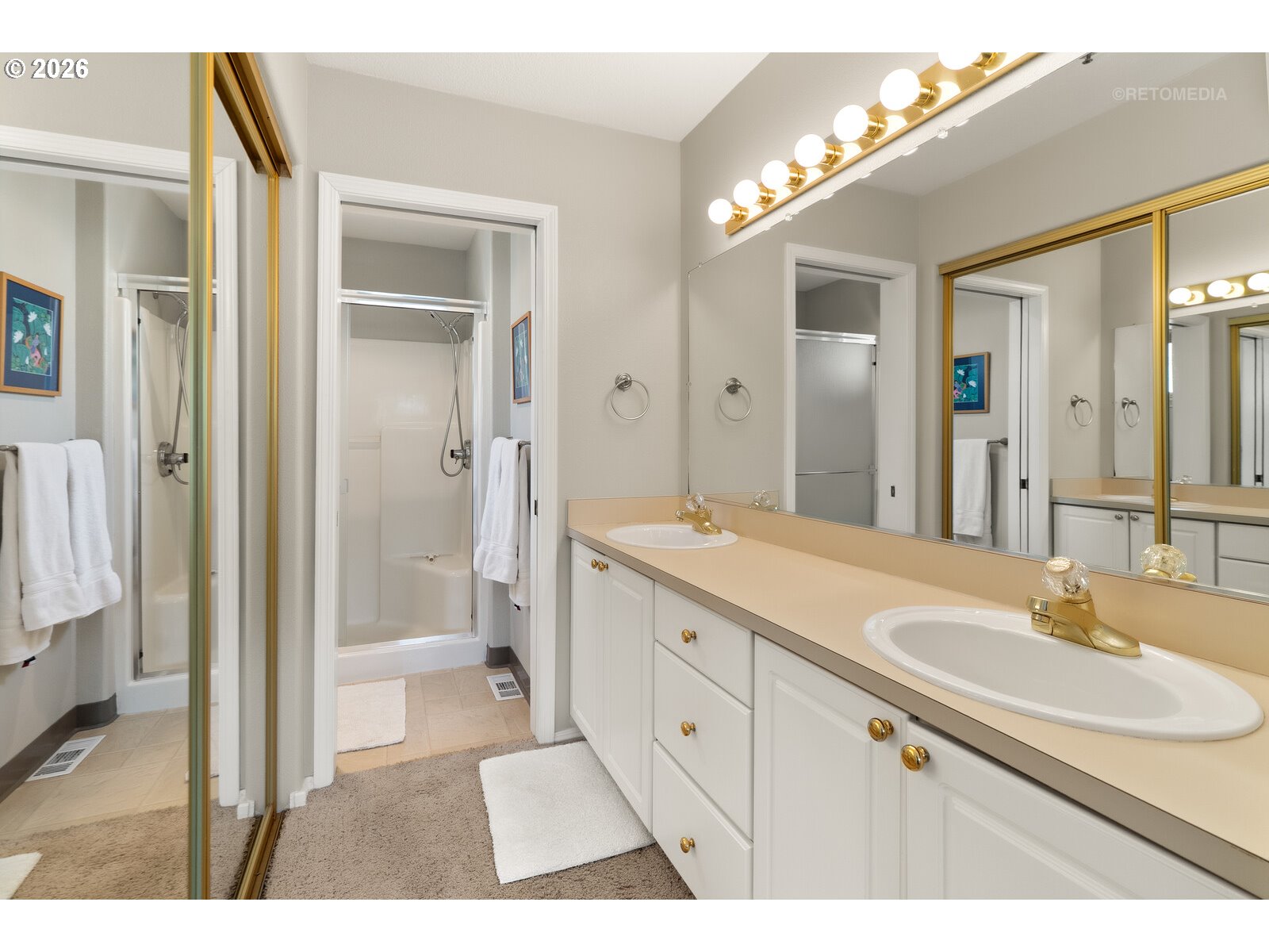 8325 Southwest Seneca Street Tualatin, OR 97062 - Photo 21 of 39 a bathroom with a sink a toilet a large mirror and shower