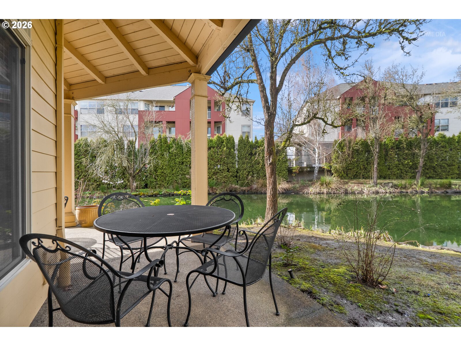 8325 Southwest Seneca Street Tualatin, OR 97062 - Photo 27 of 39 a view of a chairs and table in patio with a lake view