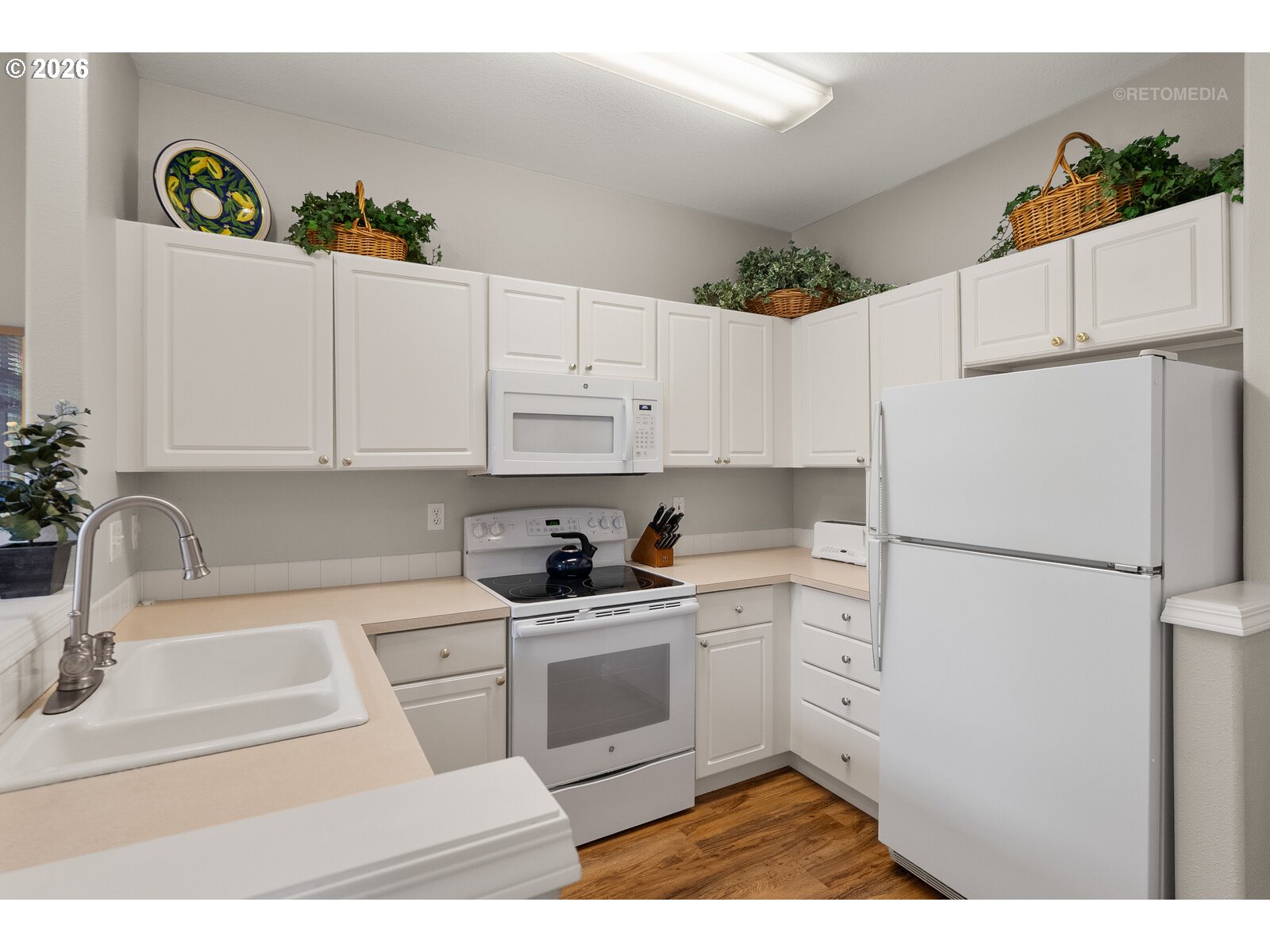 8325 Southwest Seneca Street Tualatin, OR 97062 - Photo 9 of 39 a kitchen with a white stove top oven and white refrigerator