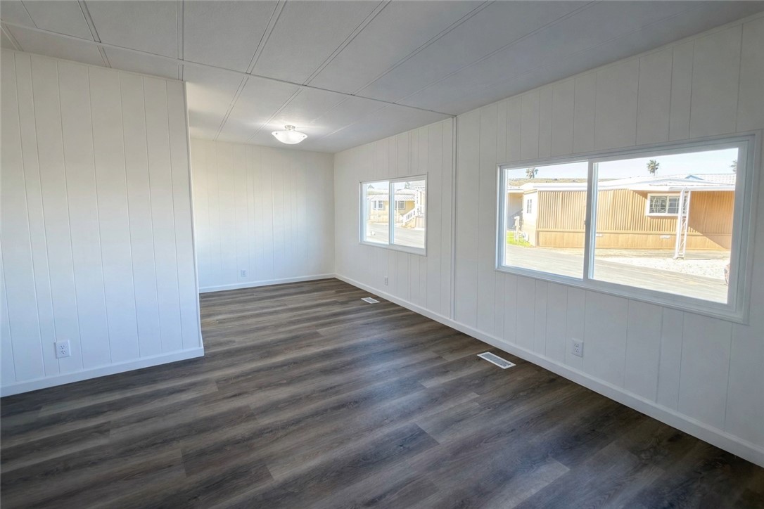 2140 Robin Avenue, Unit 2140A Oxnard, CA 93033 - Photo 3 of 17 an empty room with wooden floor and windows