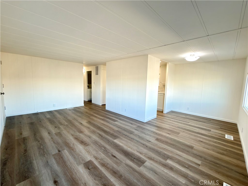 2140 Robin Avenue, Unit 2140A Oxnard, CA 93033 - Photo 4 of 17 an empty room with wooden floor and windows