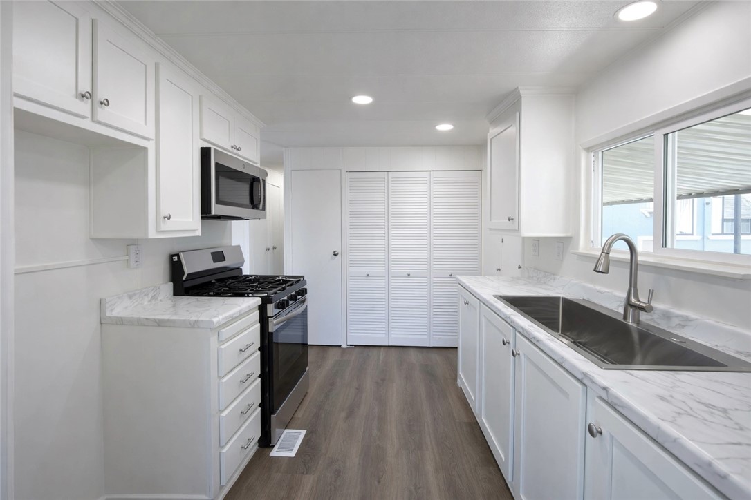 2140 Robin Avenue, Unit 2140A Oxnard, CA 93033 - Photo 5 of 17 a kitchen with a sink stove top oven and microwave