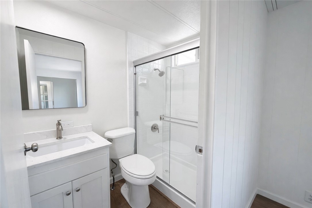 2140 Robin Avenue, Unit 2140A Oxnard, CA 93033 - Photo 8 of 17 a bathroom with a toilet sink vanity and mirror
