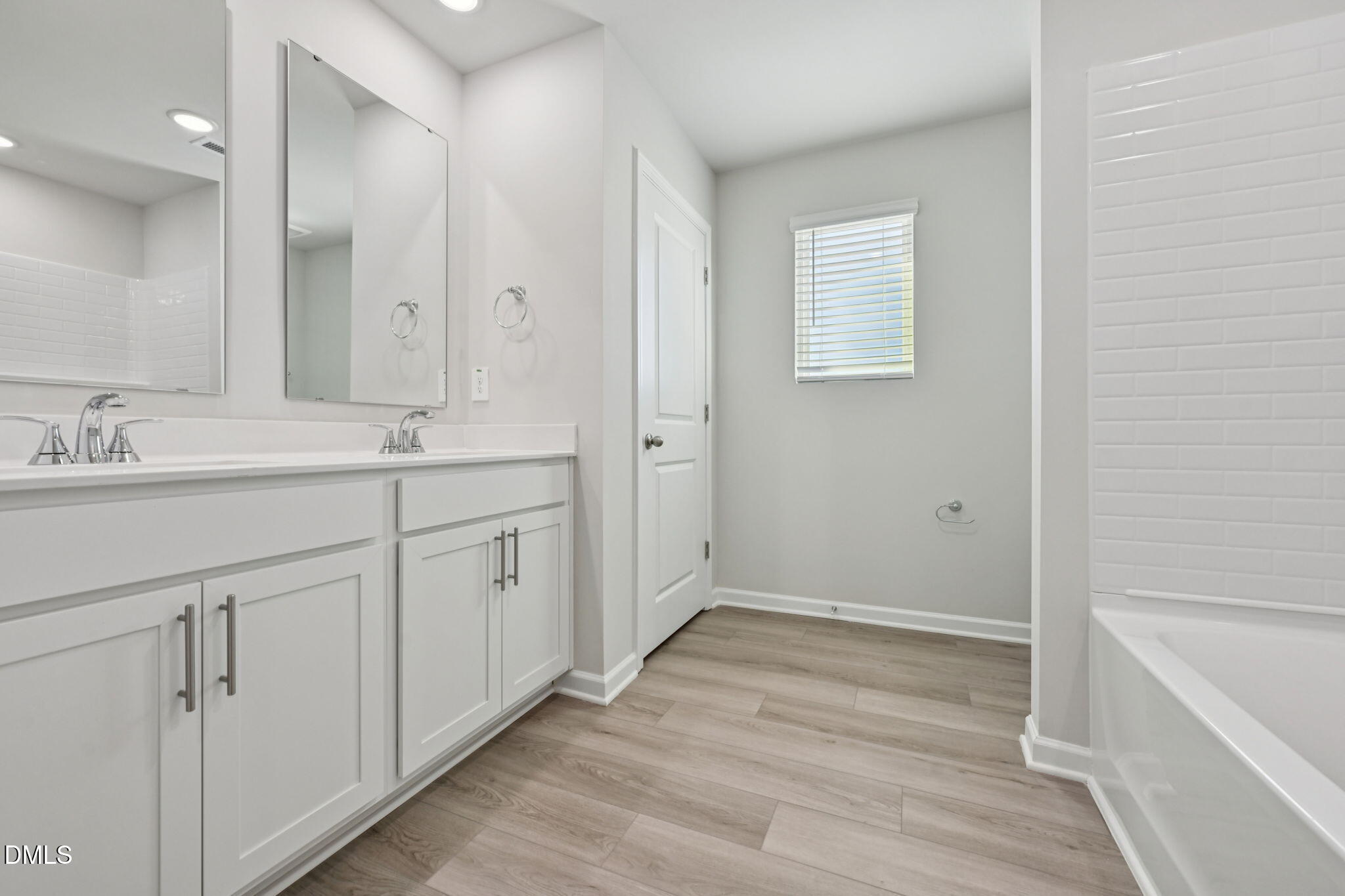2145 Topsail Road Durham, NC 27703 - Photo 31 of 49 a spacious bathroom with a double vanity sink a mirror and a
