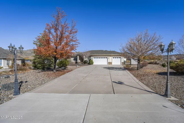 a view of house with outdoor space and tree in the background
