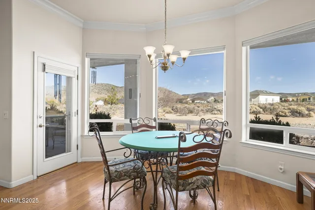 a view of a dining room with furniture large windows and wooden floor