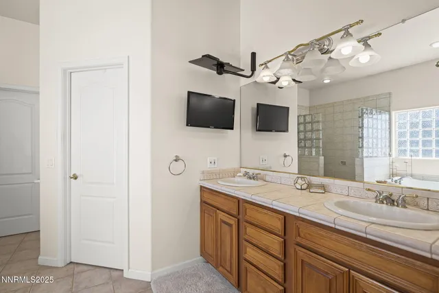 a spacious bathroom with a sink and a mirror