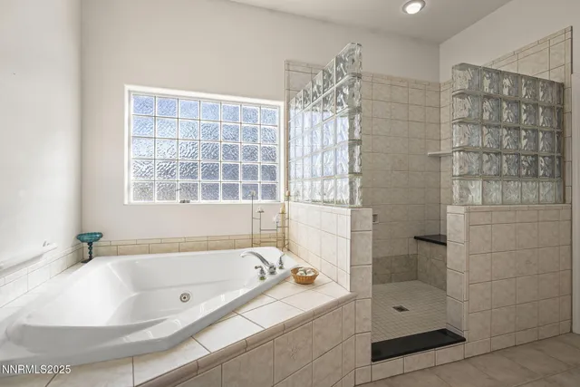a bathroom with a bathtub and shower