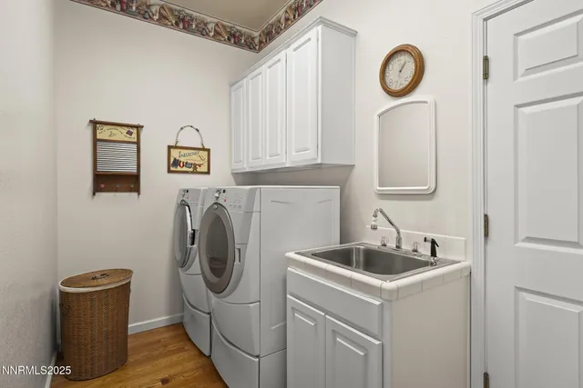 a utility room with sink dryer and washer
