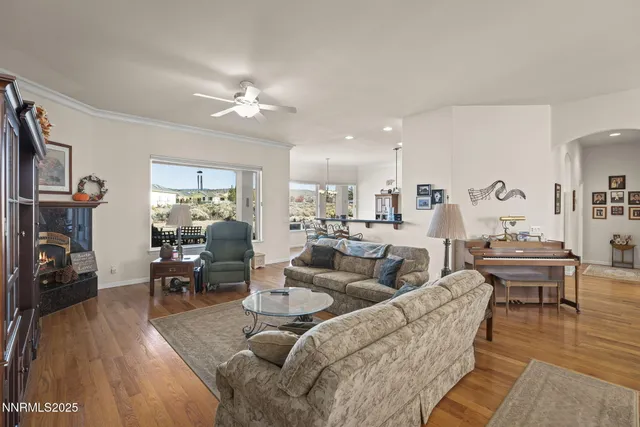 a living room with furniture and a wooden floor