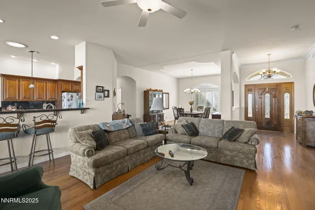 a living room with furniture and a chandelier