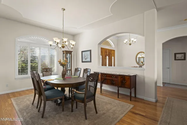 a view of a dining room with furniture and chandelier