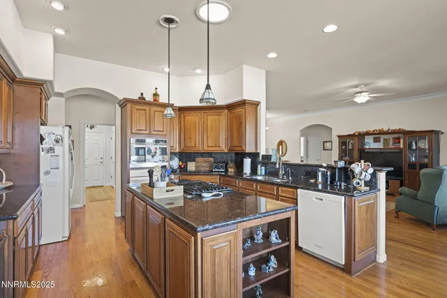 a kitchen with stainless steel appliances granite countertop a stove and a refrigerator