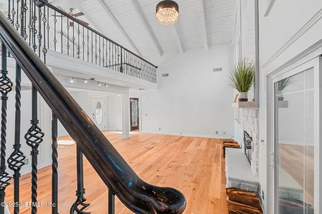 a view of room with window and wooden floor
