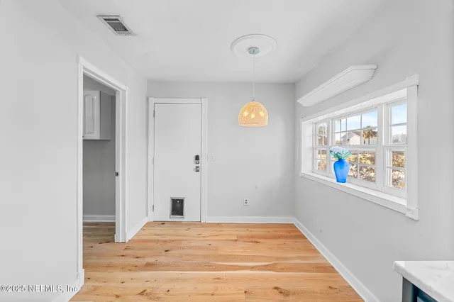 a view of a patio with table and chairs potted plants with wooden floor and seating space
